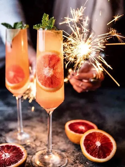We've been rocking Diwali house parties since 2012. This blood orange mimosa with a sparkler is just one example of how we bring the festive spirit to your home.