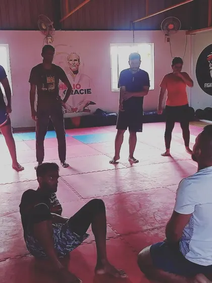 After a tough drill, we take a moment to discuss the technique. Here, I'm explaining the nuances of body positioning to a student who just completed a mount escape exercise.