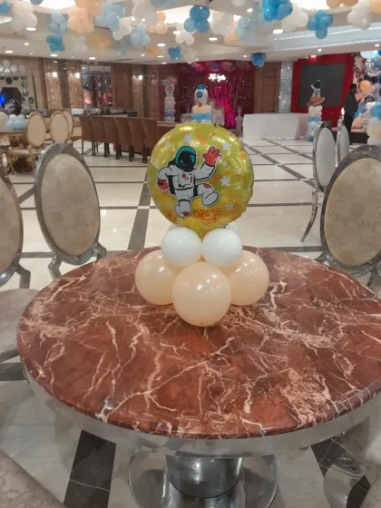 An astronaut foil balloon centerpiece for one of the guest tables. I ensure the theme is carried through every aspect of the decoration.