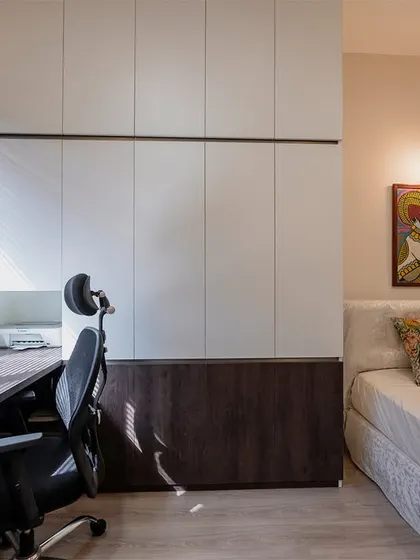 This room is designed to be a flexible space, serving as both a home office and a guest bedroom with its compact bed and integrated desk and wardrobe unit.