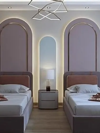 Another shared bedroom design, this one featuring elegant arched back-lit panels behind each bed. The soft lavender and neutral tones create a calm and stylish space for siblings.