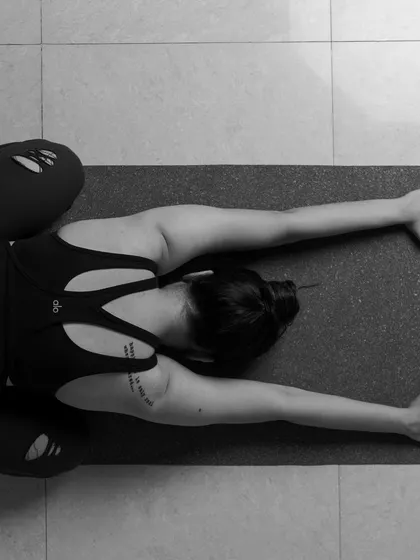 In this overhead view, I am resting in a variation of Child's Pose, a posture of surrender. The practice of controlling the senses, or Pratyahara, is about intelligently channeling our attention inward. Instead of being pulled in many directions by external stimuli, we learn to quiet the gateways of our senses to find stillness within the mind.