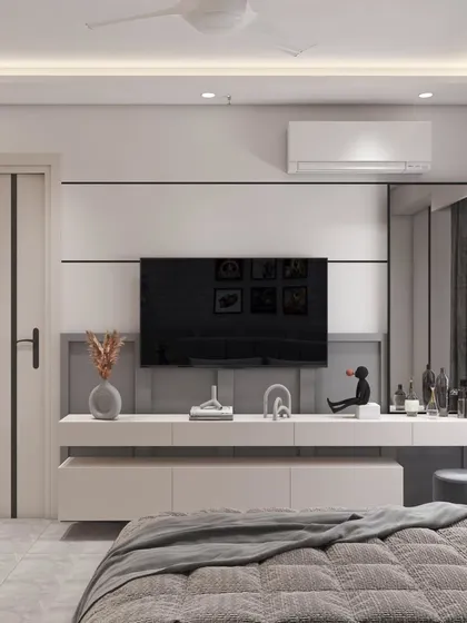 The TV and entertainment unit in the kids' room is designed to be sleek and minimalist. The floating console provides storage while keeping the floor clear, and the simple white and grey palette keeps the look clean.