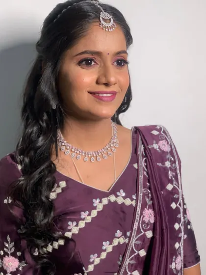 The final Sangeet look. The soft purple smokey eye and diamond jewelry create a look of pure elegance.