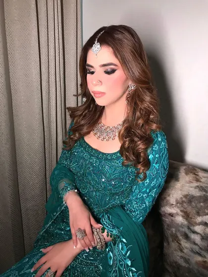 A close-up of the client's soft curls, showing the texture and shine of the hairstyle. This is a glamorous look that is perfect for any evening celebration.