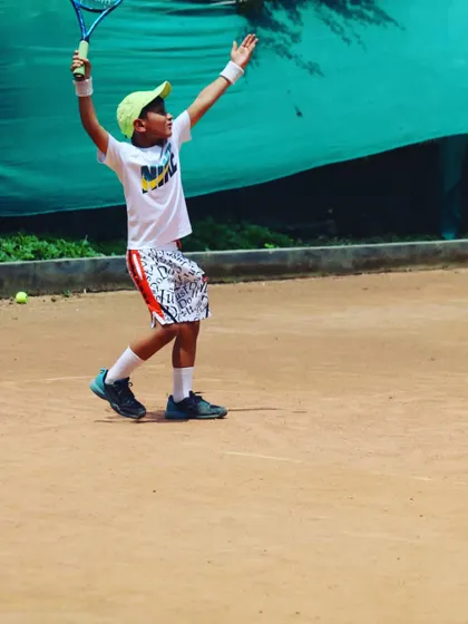 The joy of hitting a great shot! This little champ is celebrating after a powerful forehand.