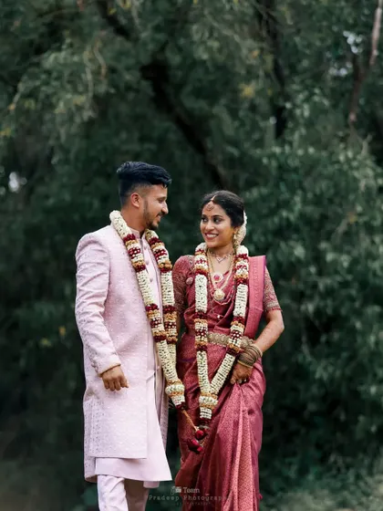 A close-up of the couple sharing a look. The focus is entirely on their connection, framed by the beautiful green surroundings.