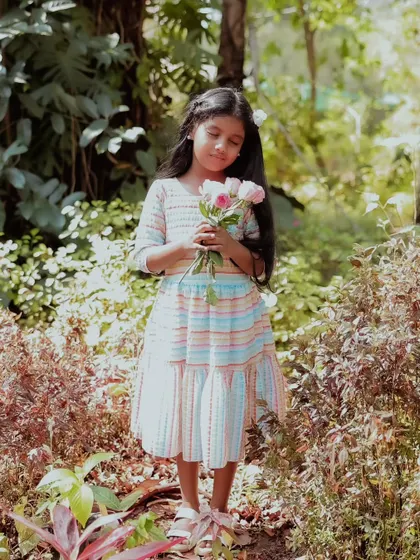 A sweet and innocent portrait of a young girl in a beautiful garden setting. I also do photoshoots for kids, capturing their natural charm and personality.