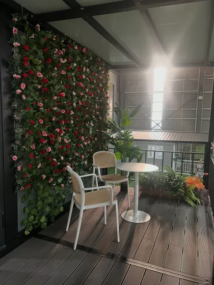 Even a small balcony can become a beautiful oasis. For this modular home, I added a vertical garden wall to bring a touch of nature and create a private, cozy outdoor seating area.