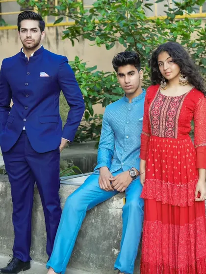 Our Jodhpuri suits are for everyone. Here you can see two different styles, one in solid royal blue and another in a lighter patterned blue, showing the variety I offer.