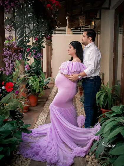 A forward-looking pose from the couple, standing together in a beautiful garden alley. This shot symbolizes them stepping into the future as parents.