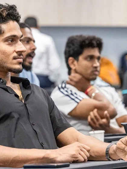 A participant at the UKSCA conference, fully engaged in one of the expert-led sessions.