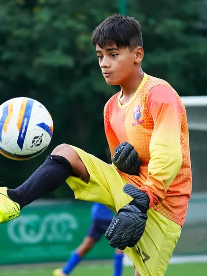 A young goalkeeper shows off his ball skills, a key attribute for modern keepers.