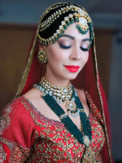 A close-up of a stunning bridal hairstyle featuring an intricate bun and a beautiful matha patti. This look is perfect for a bride who wants a detailed and glamorous wedding day style.