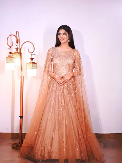 A final look at the elegant golden gown, a timeless choice for any party.