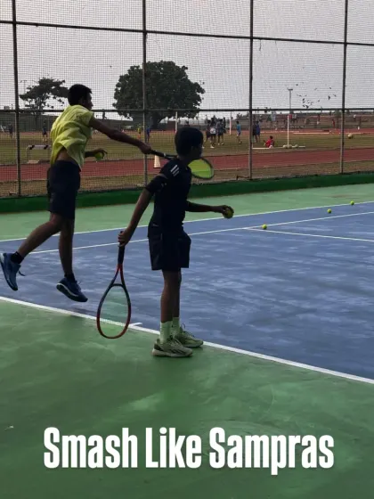 A powerful smash requires timing, technique, and confidence. Here, a coach guides a young player to execute a perfect overhead smash, a crucial skill for any aspiring champion.