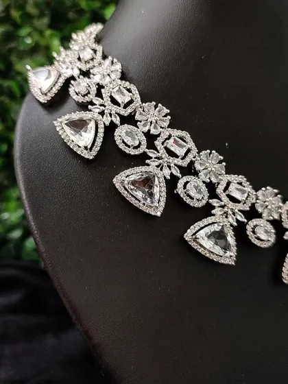 A close-up of the geometric design of this modern American Diamond necklace.