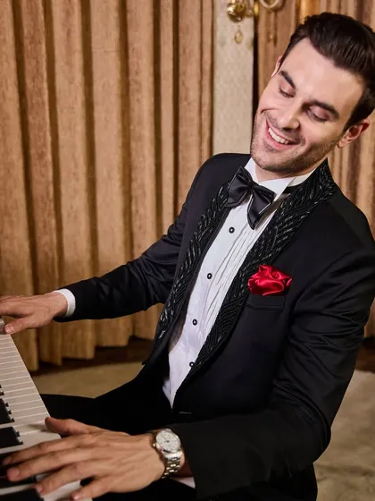 A moment of joy in a perfectly tailored tuxedo. This shot highlights the impeccable fit and the way the fabric moves with you. Whether you're at a piano bar or a wedding reception, my suits are designed to make you feel as good as you look.