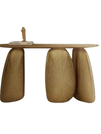 A truly sculptural console table. This piece features a slim wood top balanced on three irregularly shaped, textured gold legs, making it a functional work of art for any entryway.