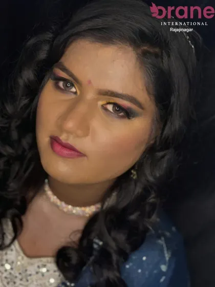 This image showcases a vibrant Haldi makeover, with the hair styled in soft curls to frame the face beautifully. Our students learn to create looks that are both traditional and modern.