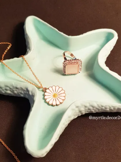 A close-up of the teal starfish tray, highlighting its shape and smooth, matte finish. It's a perfect little dish for your favorite jewelry.