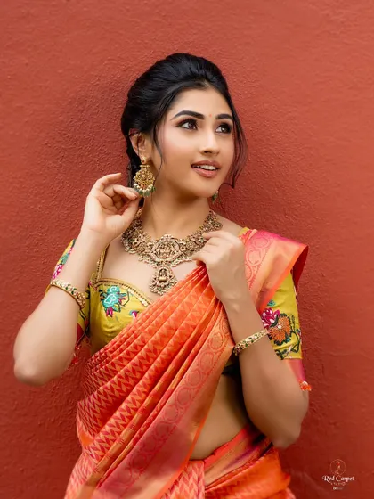 The combination of the traditional saree and the modern, colorful blouse embroidery creates a stunning fusion look.