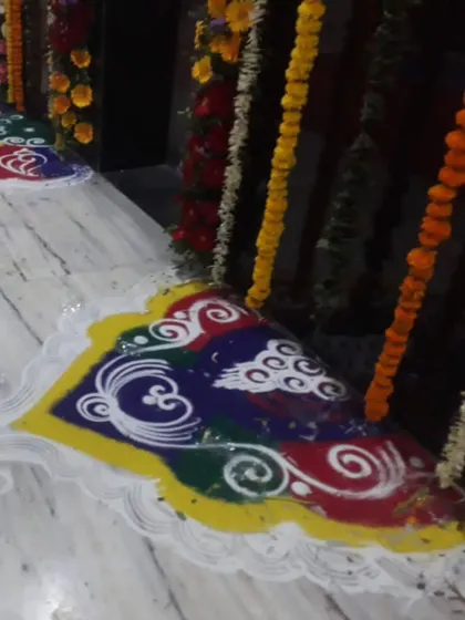 A beautiful, intricate rangoli design on the floor, adding a traditional and artistic touch to the event's decor.