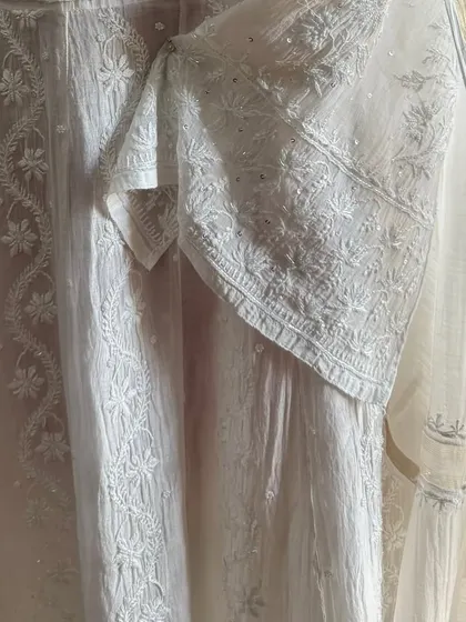 A detail shot of the sleeve and side panel, highlighting the fine craftsmanship of the Chikankari embroidery.