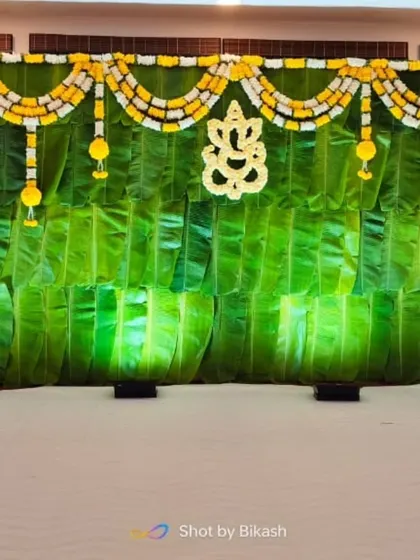 A close-up of the banana leaf backdrop with a Ganesha motif.