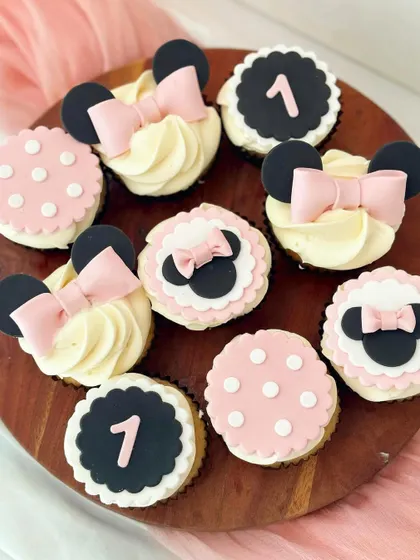 A variation of the Minnie Mouse theme, designed for a first birthday. This set includes pink and white polka-dot toppers, Minnie Mouse silhouettes, and black toppers with the number '1', showing how a theme can be customized for different ages.