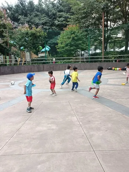The energy is contagious! Kids running and playing during a fun, game-based football session.