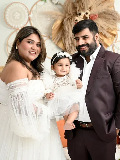 A beautiful family portrait in a dreamy boho setting. The parents' loving gaze towards their daughter makes this an incredibly warm and emotional photograph.