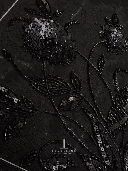 The intricate, hand-beaded embroidery on a black jacquard fabric. This is a sneak peek at the level of detail we can incorporate into our ceremonial pieces.