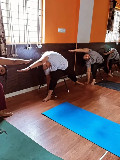 Using a chair for a supported side bend allows for greater opening along the side of the body. This is a wonderful modification for releasing tension in the waist and intercostal muscles without compromising balance.