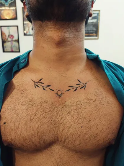 A symmetrical chest piece featuring a minimalist sun and two olive branches, symbolizing peace and new beginnings.