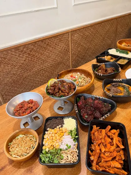 A closer look at some of the dishes from our celebratory feast, including crispy pork bhujia, Axone chicken wings, and a fresh salad.