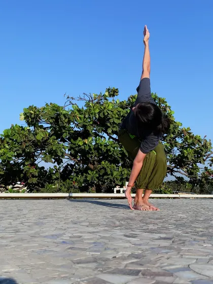Parivritta Utkatasana (Twisting Chair Pose) is a powerful detoxifying pose that strengthens the legs and core while improving spinal mobility.