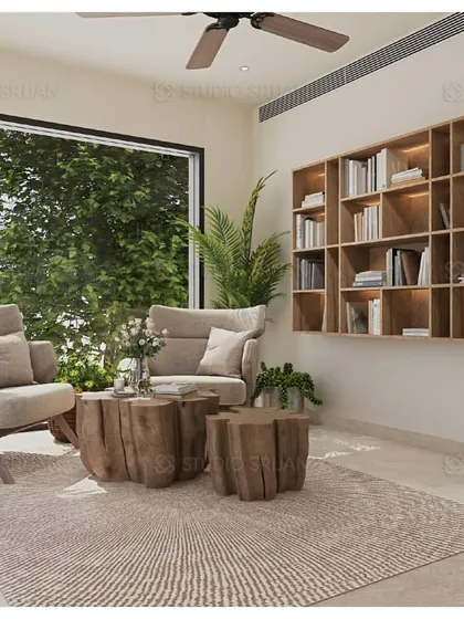 A cozy reading nook within a larger lobby area in Varanasi. The design uses natural wood furniture and a built-in bookshelf to create a warm, rustic, and inviting corner.
