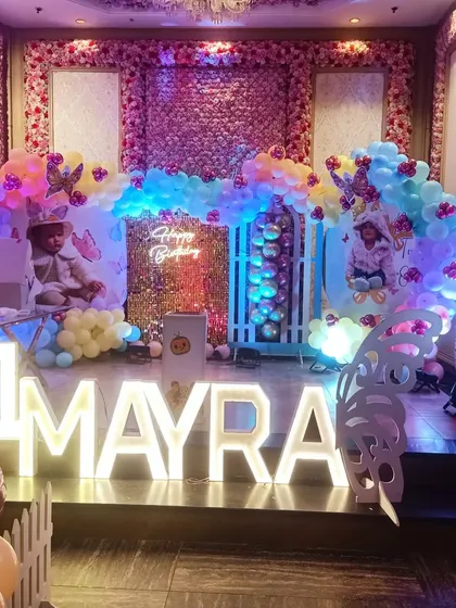 Here is a custom butterfly theme I designed for Mayra's first birthday. The setup features a beautiful balloon arch, a shimmery backdrop, and personalized photo displays to make her day extra special.