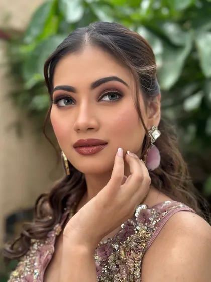 A portrait of modern elegance. The makeup is sculpted and glamorous, enhancing her features while maintaining a sophisticated feel.