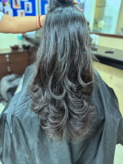Another example of a layered haircut, finished with an outward blow-dry to create soft, bouncy curls at the ends.