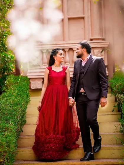 A classic and elegant walking shot of a couple on a grand staircase, with a soft, romantic edit.