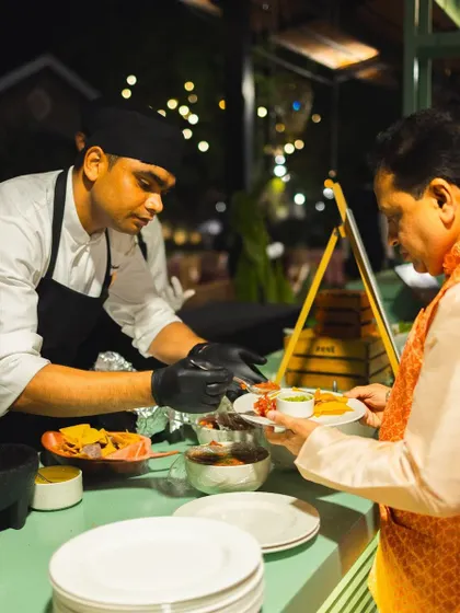 A guest receives a custom-plated dish from our interactive Mexican food station.
