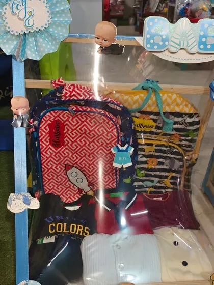 A 'Hussain's Closet' hamper with a baby bag and lots of clothes, all part of the Boss Baby theme.