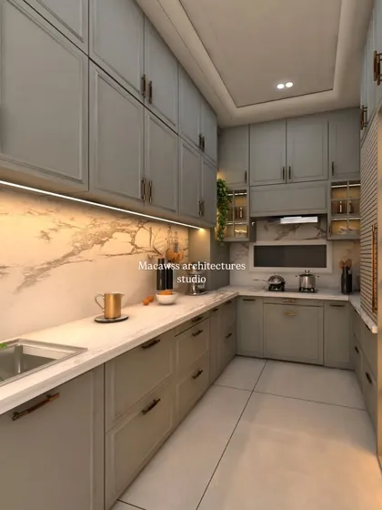 This modern kitchen design focuses on a clean, uncluttered aesthetic with maximum functionality. It features handleless cabinets in a calming earth tone, a marble backsplash, and integrated under-cabinet lighting for a seamless look.