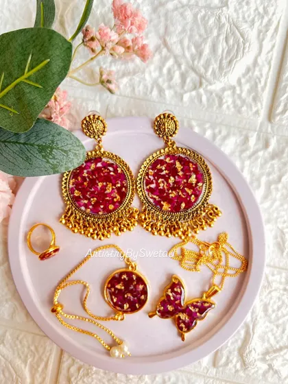 A full set of my real rose petal resin jewelry, including statement earrings, a delicate bracelet, a ring, and a butterfly pendant.