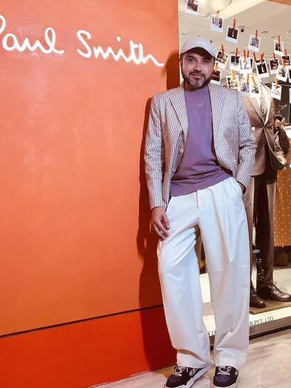 Attending a collection preview for Paul Smith. Here I am, styled in a pinstripe blazer and relaxed trousers, ready to explore the latest in sartorial menswear.