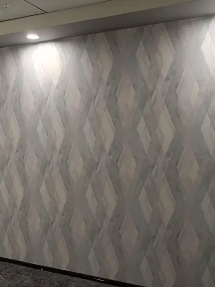 A grey wallpaper with a 3D diamond pattern.