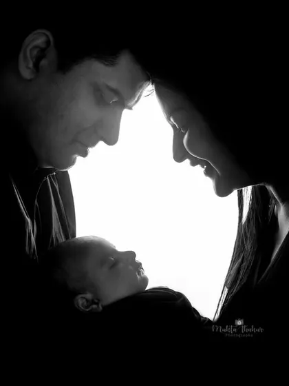 A creative silhouette shot that beautifully captures the love surrounding a new baby.