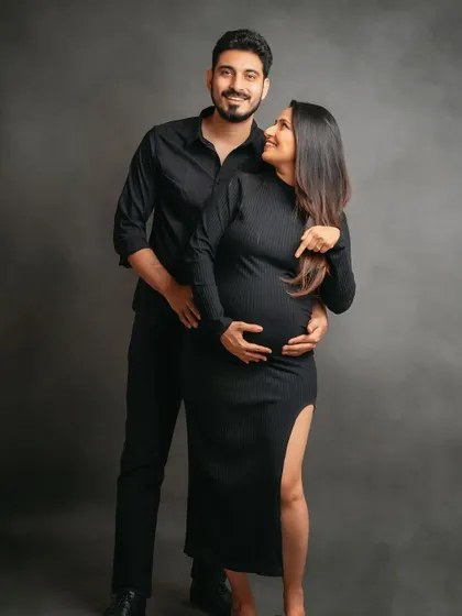 This stylish couple is ready for their new arrival. The all-black outfits create a chic and modern look for their maternity photos.